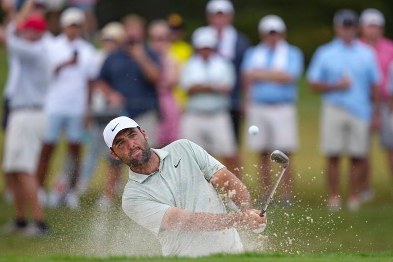 Scottie Scheffler hits from a bunker on the sixth hole during the final round of the Tour Championship golf tournament, Sunday, Sept. 1, 2024, in Atlanta. (AP Photo/Jason Allen)