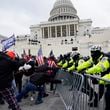 Insurrectionists loyal to then-President Donald Trump try to break through a police barrier at the U.S. Capitol in Washington on Jan. 6, 2021. (AP Photo/Julio Cortez, File)