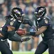 Baltimore Ravens running back Derrick Henry, left, takes a handoff from quarterback Lamar Jackson while running for a long touchdown against the Buffalo Bills during the first half of an NFL football game, Sunday, Sept. 29, 2024, in Baltimore. (AP Photo/Stephanie Scarbrough)