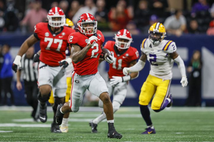 Georgia Bulldogs running back Kendall Milton (2) runs for a 51-yard gain against the LSU Tigers during the second half of the SEC Championship Game at Mercedes-Benz Stadium in Atlanta on Saturday, Dec. 3, 2022. (Jason Getz / Jason.Getz@ajc.com)