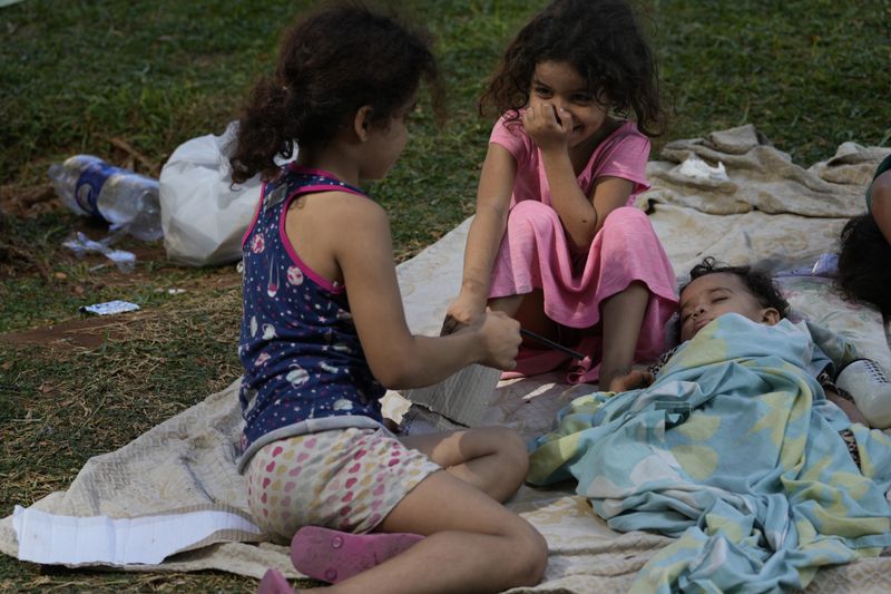 Kids who fled with their families the southern suburb of Beirut amid ongoing Israeli airstrikes, rest in a park in downtown Beirut, Lebanon, Saturday, Sept. 28, 2024. (AP Photo/Hussein Malla)