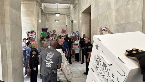 FILE - Boxes containing signatures supporting a proposed ballot measure to scale back Arkansas' abortion ban are delivered to a room in the state Capitol, July 5, 2024, in Little Rock, Ark. (AP Photo/Andrew DeMillo, File)