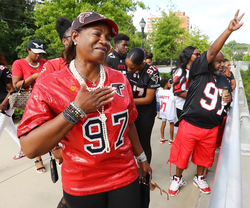 091320 Atlanta: Elisha Jarrett (left), the mother of Atlanta Falcons defensive tackle Grady Jarrett, becomes emitional as his family cheers him on outside Mercedes-Benz Stadium while he arrives to play the Seattle Seahawks in the home opener of a NFL football game on Sunday, Sept. 13, 2020 in Atlanta. Ms. Jarrett has never missed a home or away game her son has played in since pee-wee football and said “this is the first time I will not be able to touch him. We always share a fist pump before the start of each game. Today will be a little different”.   “Curtis Compton / Curtis.Compton@ajc.com”
