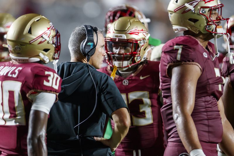 Florida State head coach Mike Norvell, center left, is surrounded by his team in the final seconds of an NCAA college football game against Boston College, Monday, Sept. 2, 2024, in Tallahassee, Fla. (AP Photo/Colin Hackley)