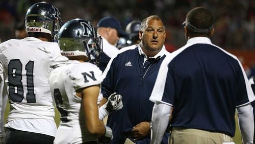 Norcross head coach Keith Maloof (center) talks with players and coaches in the fourth quarter of a victory over Parkview.