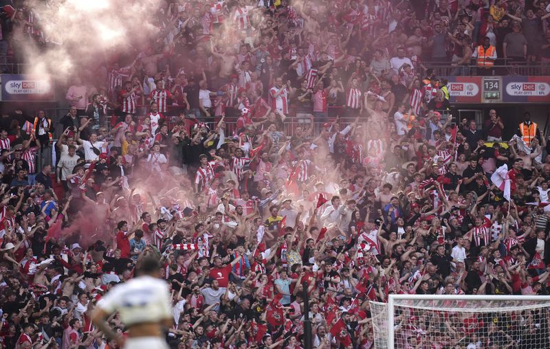 Southampton fans celebrate their promotion to the Premier League after defeating Leeds United in the Championship play-off final at Wembley Stadium, London, Sunday May 26, 2024. (Adam Davy/PA via AP)