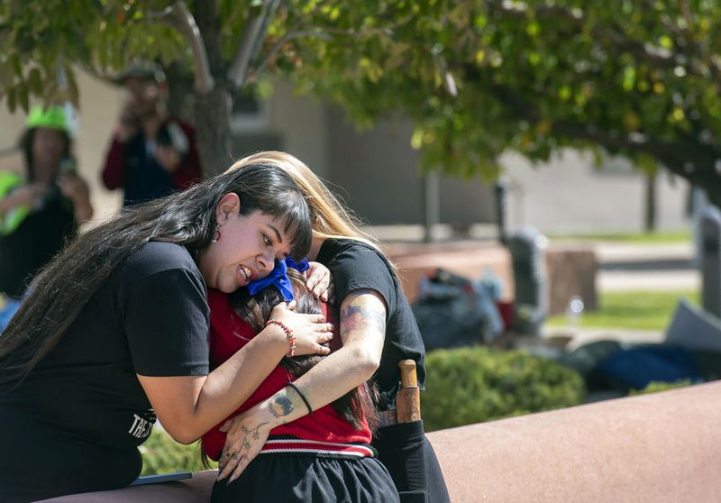 FILE - Jennifer Marley, San Ildefonso Pueblo, and others hug after a man was shot during a rally to protest a statue of Juan Onate that was to be resurrected outside the Rio Arriba County building, in Espanola, N.M., Thursday, Sept. 28, 2023. (Eddie Moore/The Albuquerque Journal via AP, File)