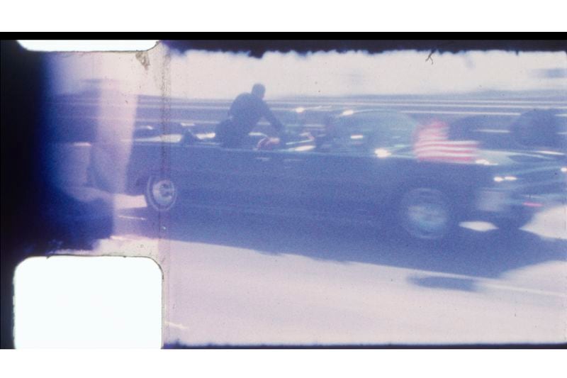 FILE - An undated image released by RR Auction shows home film footage of President John F. Kennedy's motorcade speeding down a Dallas freeway to the hospital after he was fatally wounded on Nov. 22, 1963. (RR Auction via AP, File)