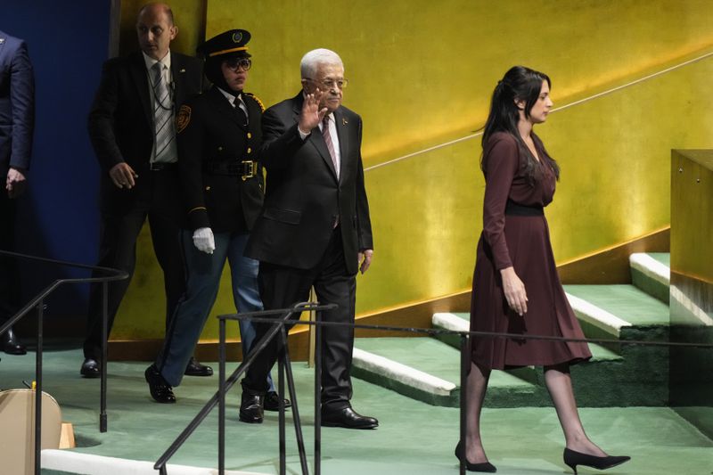 Palestinian President Mahmoud Abbas is escorted to the podium to address the 79th session of the United Nations General Assembly, Thursday, Sept. 26, 2024, at U.N. headquarters. (AP Photo/Frank Franklin II)