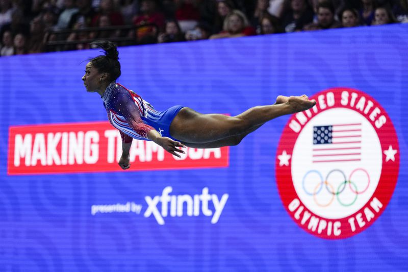 Simone Biles competes in the floor exercise at the United States Gymnastics Olympic Trials on Sunday, June 30, 2024, in Minneapolis. (AP Photo/Charlie Riedel)