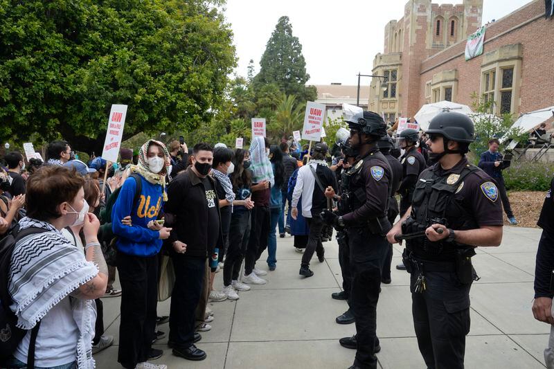 Pro-Palestinian demonstrators and police face off on the UCLA campus Thursday, May 23, 2024, in Los Angeles. (AP Photo/Damian Dovarganes)