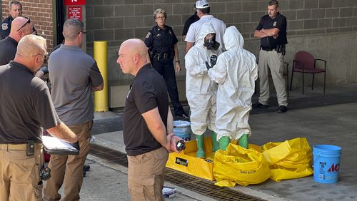 A hazmat crew from the National Guard's Civilian Support Team investigates after a suspicious package was delivered to election officials at the Missouri Secretary of State's Jefferson City, Mo., office on Tuesday Sept. 17, 2024. (AP Photo/Summer Ballentine)