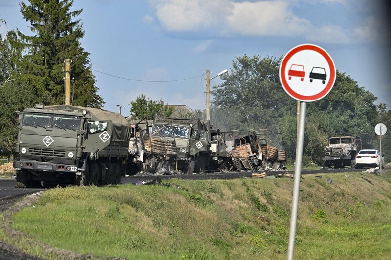 FILE - A column of Russian army trucks damaged by shelling by Ukrainian forces is seen on the highway in the Sudzhansky district in the Kursk region of Russia, on Aug. 9, 2024. (Anatoliy Zhdanov/Kommersant Publishing House via AP, File)