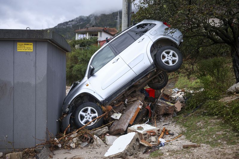 A damaged car is seen after flood hit the village of Donja Jablanica, Bosnia, Saturday, Oct. 5, 2024. (AP Photo/Armin Durgut)