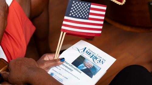 A person holds the program for a Naturalization ceremony at Jimmy Carter National Historic Park in Plains on Tuesday, Oct. 1, 2024. The ceremony was held in honor of President Carter’s 100th birthday.  Ben Gray for the Atlanta Journal-Constitution