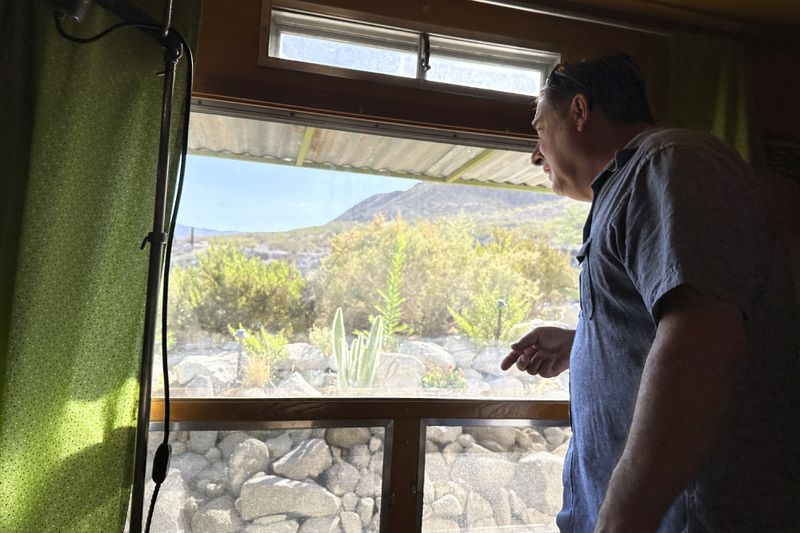 Robert Ardovino, a partner in a decades-old family restaurant business, surveys his property on the U.S. border with Mexico in Sunland Park, N.M., Thursday, Aug. 22, 2024. Ardovino has a close-up view of border enforcement efforts and bristles at politicians talking from afar about an "open border." The politics of immigration look different from communities on the Southwest border that are voting in hotly contested congressional races. (AP Photos/Morgan Lee)