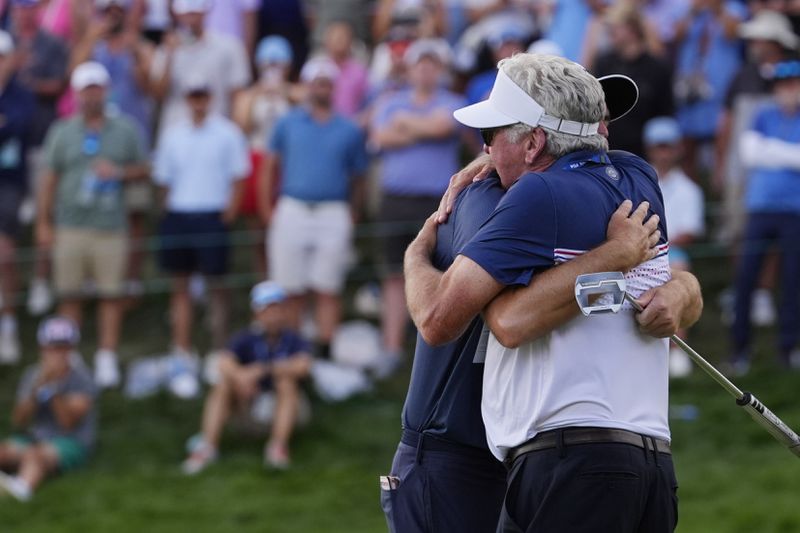 Keegan Bradley, left, embraces his father Mark Bradley after winning the BMW Championship golf event at Castle Pines Golf Club, Sunday, Aug. 25, 2024, in Castle Rock, Colo. (AP Photo/Matt York)