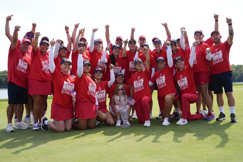 United States players poses for photographs after the United States won the Solheim Cup golf tournament against Europe at the Robert Trent Jones Golf Club, Sunday, Sept. 15, 2024, in Gainesville, Va. (AP Photo/Matt York)