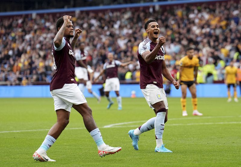 Aston Villa's Ollie Watkins, right, celebrates scoring during the English Premier League soccer match between Aston Villa and Wolverhampton Wanderers at Villa Park, Birmingham, England, Saturday Sept. 21, 2024. (Martin Rickett/PA via AP)