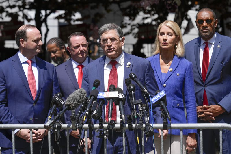 U.S. Rep. Andrew Clyde (center), R-Athens, speaks to reporters at a park outside of the criminal trial for former President Donald Trump in New York on Monday.