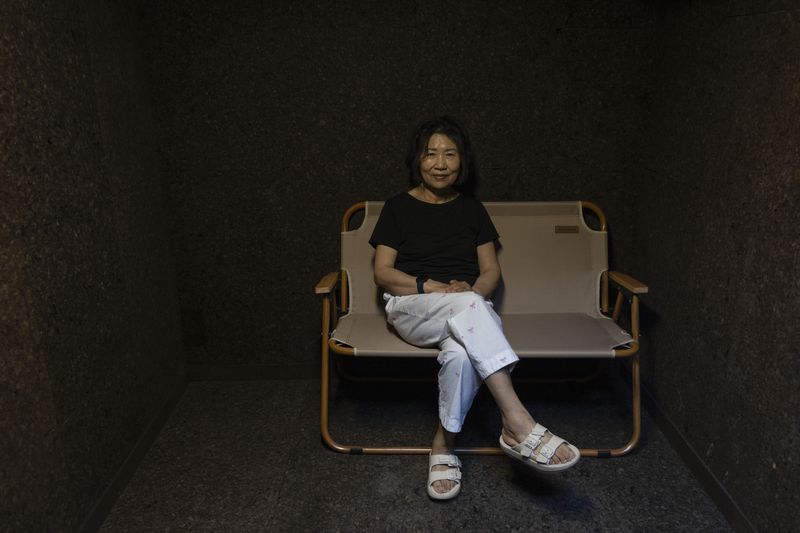 Jung Myungja, 73, sits for a portrait in a small bunker dug into the yard of her home in Seoul, Tuesday, May 28, 2024. (AP Photo/Jae C. Hong)