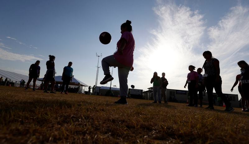 FILE- In this July 9, 2019, photo, immigrants play soccer at the U.S. government's newest holding center for migrant children in Carrizo Springs, Texas. For 27 years, federal courts have held special oversight over custody conditions for child migrants. The Biden administration wants a judge to partially lift those powers on Friday, June 21, 2024. (AP Photo/Eric Gay, File)