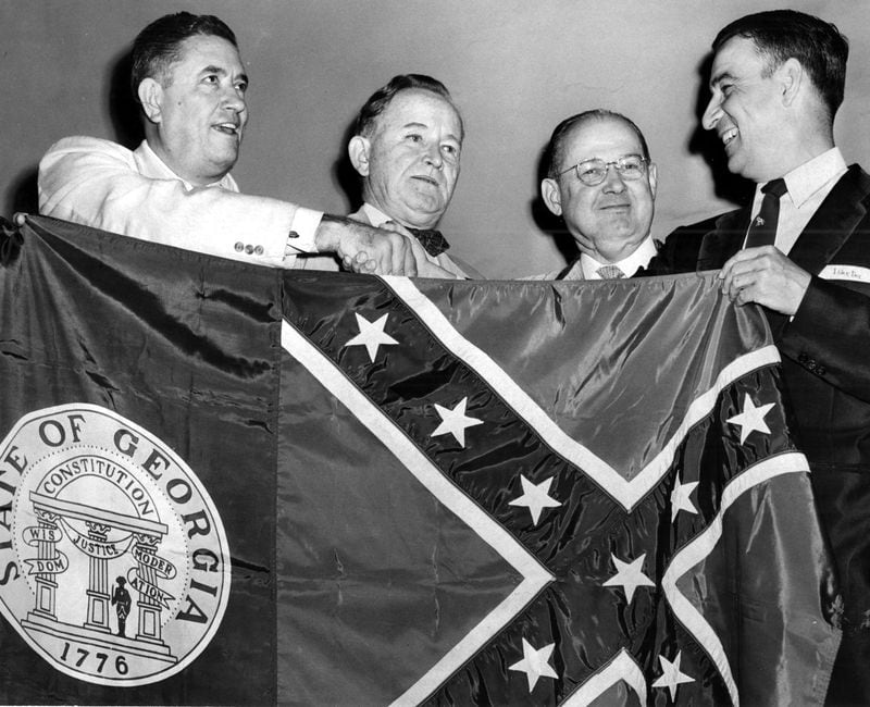 The Georgia state flag was changed Feb. 13, 1956, incorporating a Confederate battle emblem into the design, as a response to the Supreme Court rulings on desegregating schools. The original 1956 caption for this photo reads "Two Georgia Democrats, at left, Frank Etheridge and Judge Gus Roan, present a new state flag to Republicans Ray Spitler and W.B. Shartzer to take to the GOP national convention at San Francisco. Shartzer promised to display the banner with its Confederate symbol."