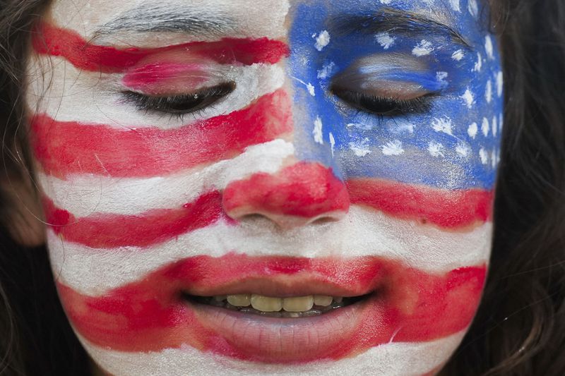 Jessica Mitchell is seen with her faces painted like the American flag during the annual Freedom Over Texas Festival at Eleanor Tinsley Park on the Fourth of July, Thursday, July 4, 2024, in Houston. Mitchell said it took her 45 minutes to complete her patriotic face paint. (Jason Fochtman/Houston Chronicle via AP)