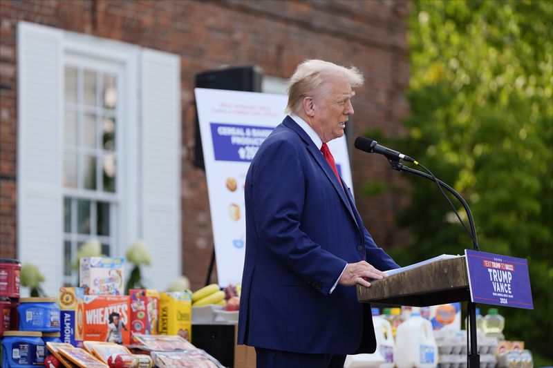 With consumer goods placed on tables near him, Republican presidential nominee former President Donald Trump speaks at a news conference at Trump National Golf Club, Thursday, Aug. 15, 2024, in Bedminster, N.J. (AP Photo/Julia Nikhinson)