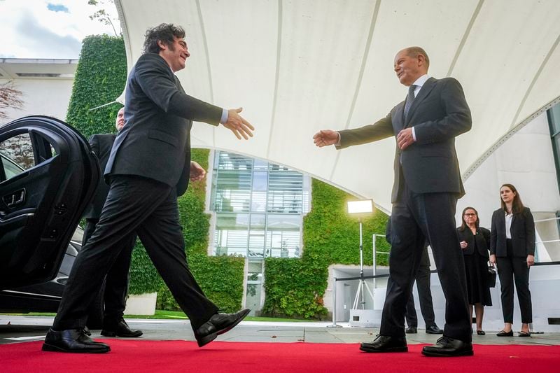 German Chancellor Olaf Scholz, right, and Argentina's President Javier Milei shake hands during their meeting at the chancellery in Berlin, Germany, Sunday, June 23, 2024. (Kay Nietfeld/dpa via AP)