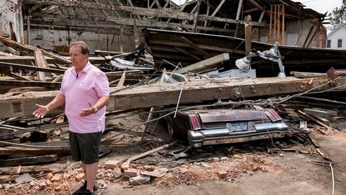 Scott Smith, owner of Scotty's Smoke House Barbecue stands by what's left of the large warehouse that was headquarters for his businesses, Tuesday, July 23, 2024 in Rome, N.Y. Cleanup continues around the heavily damaged city center after an EF2 tornado touched down one week earlier. (AP Photo/Craig Ruttle)