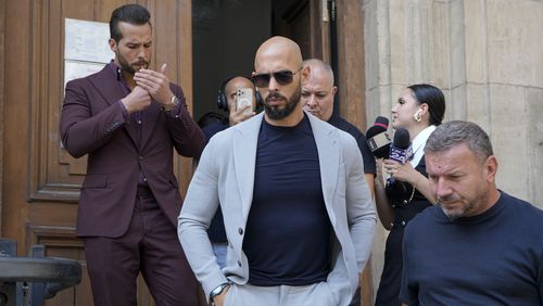 Andrew Tate, center, and his brother Tristan, left, walk outside the Court of Appeals building, after a hearing, in Bucharest, Romania, Wednesday, Sept. 4, 2024. (AP Photo/Vadim Ghirda)