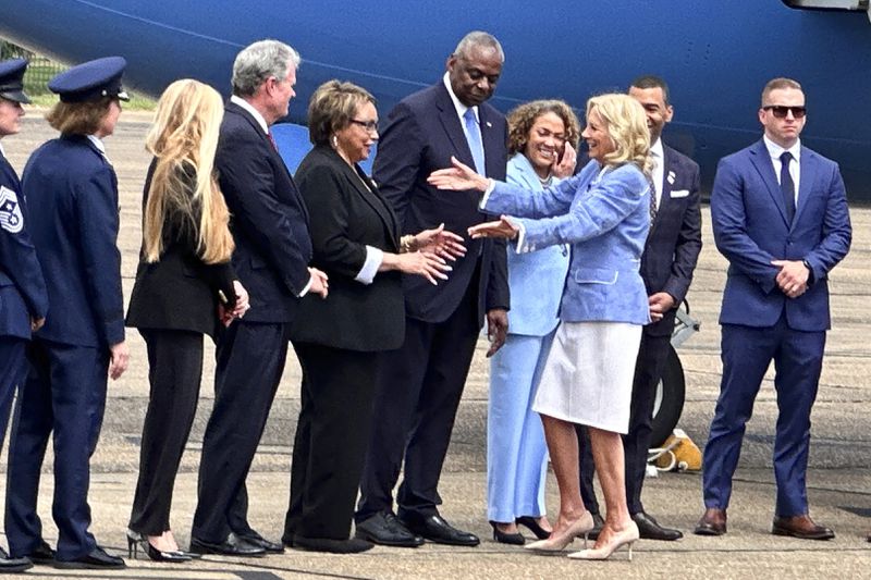 First lady Jill Biden is greeted by Charlene Austin as she arrives at Maxwell Air Force Base in Alabama, as Defense Secretary Lloyd Austin and others look on, Friday, Sept. 13, 2024. (AP Photo/Tara Copp)