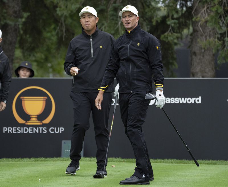 International team members Byeong Hun An, of South Korea, left, and Adam Scott, of Australia, during practice for the Presidents Cup golf tournament at Royal Montreal Golf Club in Montreal, Wednesday, Sept. 25, 2024. (Ryan Remiorz/The Canadian Press via AP)