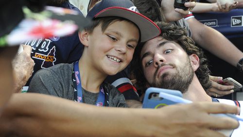 Dansby Swanson of the Braves, right, poses with 9-year-old fan Caleb Zurawick of Chattanooga, Tenn., before a baseball game against the Philadelphia Phillies, Wednesday, Sept. 28, 2016, in Atlanta. (AP Photo/John Amis)