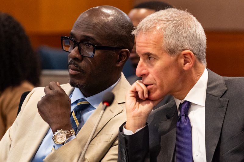 Young Thug attorney Keith Adams, left, confers with Young Thug attorney Brian Steel during the ongoing “Young Slime Life” gang trial at the Fulton County Courthouse in Atlanta on Friday, July 19, 2024. (Seeger Gray / AJC)