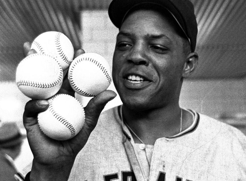 FILE - San Francisco Giants outfielder Willie Mays displays the four baseballs in the clubhouse representing the four homers which he hit against the Milwaukee Braves, April 30, 1961, in Milwaukee. Mays, the electrifying “Say Hey Kid” whose singular combination of talent, drive and exuberance made him one of baseball’s greatest and most beloved players, has died. He was 93. Mays' family and the San Francisco Giants jointly announced Tuesday night, June 18, 2024, he had “passed away peacefully” Tuesday afternoon surrounded by loved ones. (AP Photo, File)