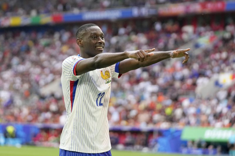 Randal Kolo Muani of France celebrates his side's first goal during a round of sixteen match between France and Belgium at the Euro 2024 soccer tournament in Duesseldorf, Germany, Monday, July 1, 2024. (AP Photo/Darko Vojinovic)