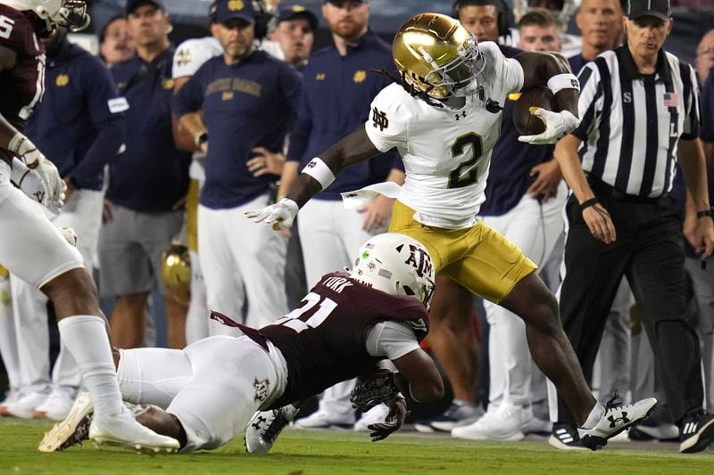 Notre Dame wide receiver Jayden Harrison (2) is tackled by Texas A&M linebacker Taurean York (21) after a first down run during the first half of an NCAA college football game Saturday, Aug. 31, 2024, in College Station, Texas. (AP Photo/Sam Craft)