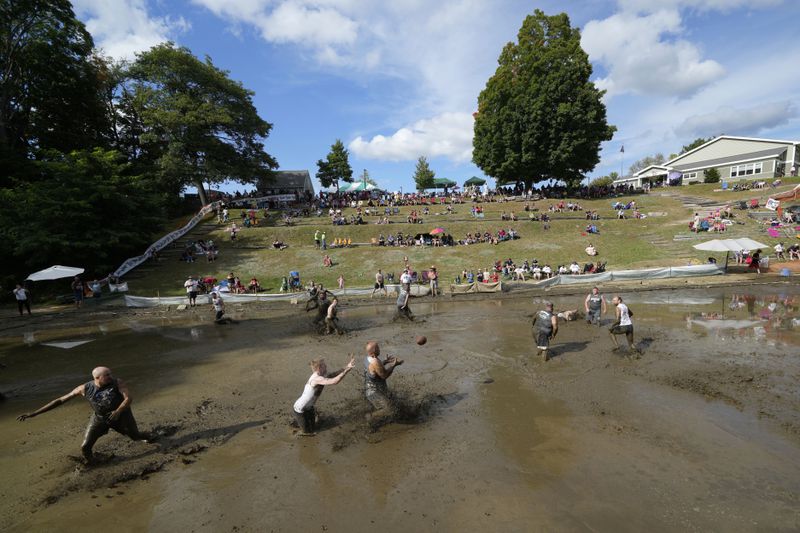 The Muckaneers take on the Muddas' at the 2024 Mud Bowl football game at Hog Coliseum Saturday, Sept. 7, 2024, in North Conway, N.H. (AP Photo/Robert F. Bukaty)