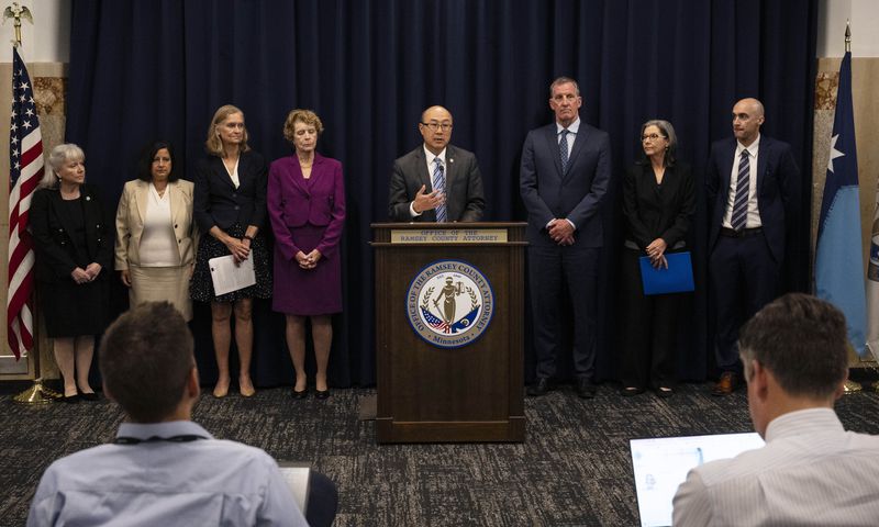 Ramsey County Attorney John Choi, center, discusses his office's review of former Ramsey County Medical Examiner Michael McGee's work during a news conference in St. Paul, Minn. on Wednesday, Sept. 11, 2024. (John Autey/Pioneer Press via AP)