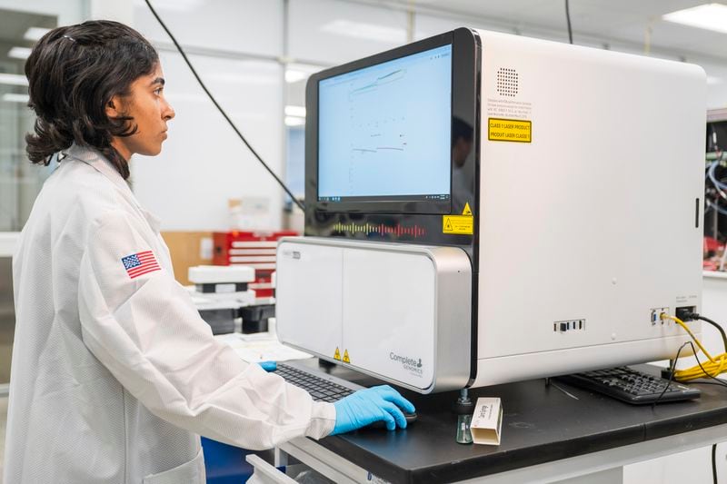 A lab technician works on a sequencer inside the quality control department at Complete Genomics in San Jose, Calif., Monday, July 22, 2024. (AP Photo/Nic Coury)