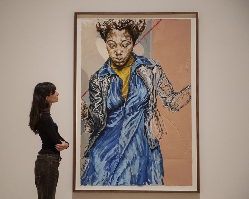 A woman looks at an artwork by Claudette Johnson during the Turner Prize 2024 press preview at Tate Britain in London, part of the 40th anniversary exhibition featuring four shortlisted artists, Tuesday, Sept. 24, 2024. (AP Photo/Thomas Krych)