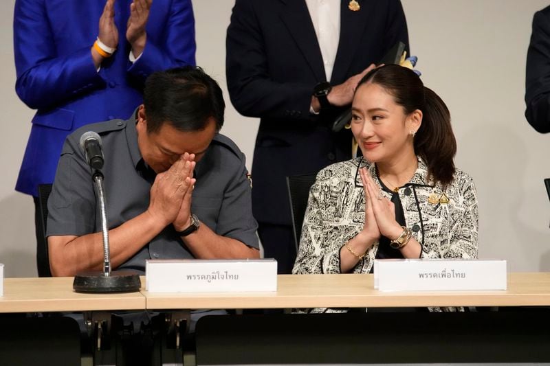 Leader of Pheu Thai Party, Paetongtarn Shinawatra, daughter of Thailand's former Prime Minister Thaksin Shinawatra, right, and coalition partners guture during press conference in Bangkok, Thailand, Thursday, Aug. 15, 2024. (AP Photo/Sakchai Lalit)