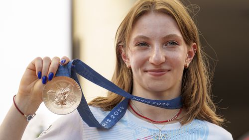 Romanian gymnast Ana Barbosu poses with the bronze medal for her women's artistic gymnastics individual floor performance at the Paris 2024 Olympics, after receiving it during a ceremony at the Romanian Olympic and Sports Committee, in Bucharest, Romania, Friday, Aug. 16, 2024. American gymnast Jordan Chiles called an arbitration panel's decision that dropped her out of the bronze medal position in the floor exercise at the Paris Olympics "unjust" and a "significant blow" in a message posted on social media Thursday. (AP Photo/Vadim Ghirda)