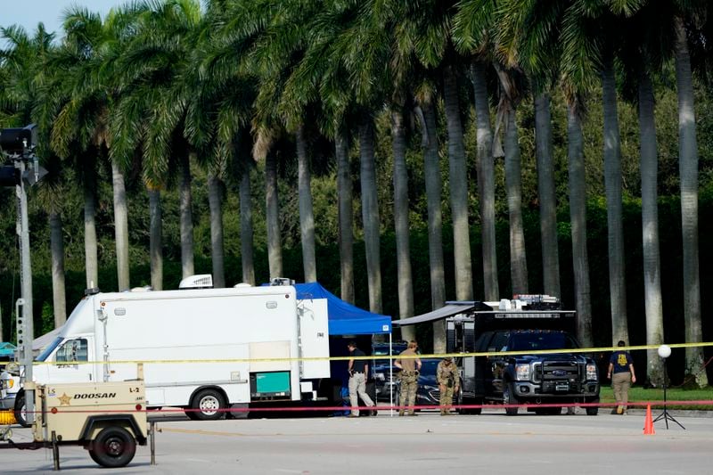 Law enforcement officials work outside of Trump International Golf Club after the apparent assassination attempt of Republican presidential nominee and former President Donald Trump Monday, Sept. 16, 2024, in West Palm Beach, Fla. (AP Photo/Lynne Sladky)