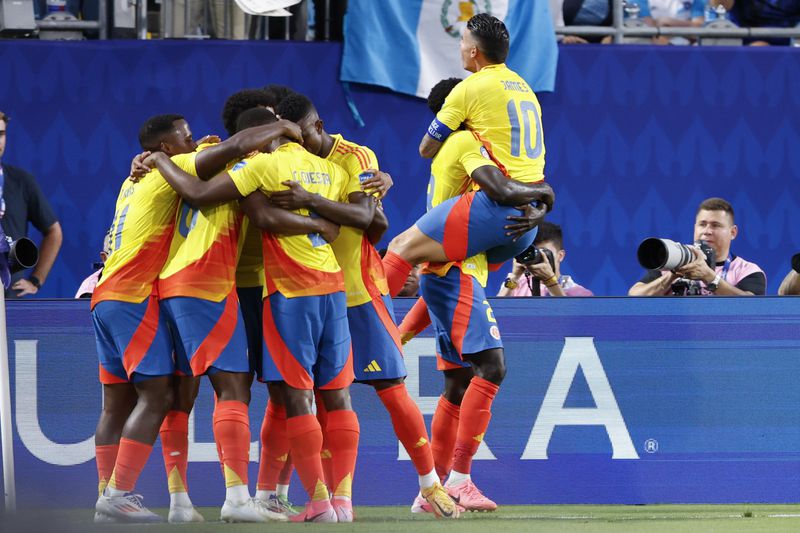 Players of Colombia celebrate their side's opening goal against Uruguay scored by teammate Jefferson Lerma during a Copa America semifinal soccer match in Charlotte, N.C., Wednesday, July 10, 2024. (AP Photo/Nell Redmond)