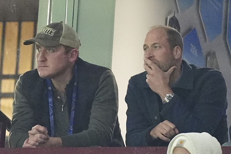 Britain's Prince William, right, watches the Champions League opening phase soccer match between Aston Villa and Bayern Munich, at Villa Park in Birmingham, England, Wednesday, Oct. 2, 2024. (Mike Egerton/PA via AP)