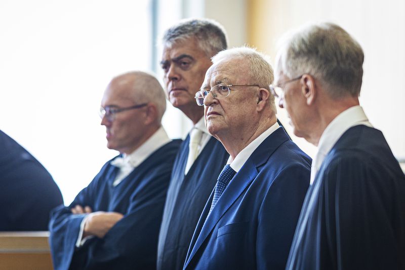 Former Volkswagen Group CEO Martin Winterkorn, second right, stands between his defense lawyers in a hall of the Braunschweig Regional Court in Brunswick, Germany, Tuesday, Sept. 3, 2024. (Moritz Frankenberg/dpa via AP)