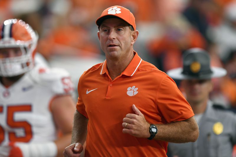 FILE - Clemson head coach Dabo Swinney runs on the field during the first half of an NCAA college football game against Syracuse in Syracuse, N.Y., Sept. 30, 2023. (AP Photo/Adrian Kraus, File)